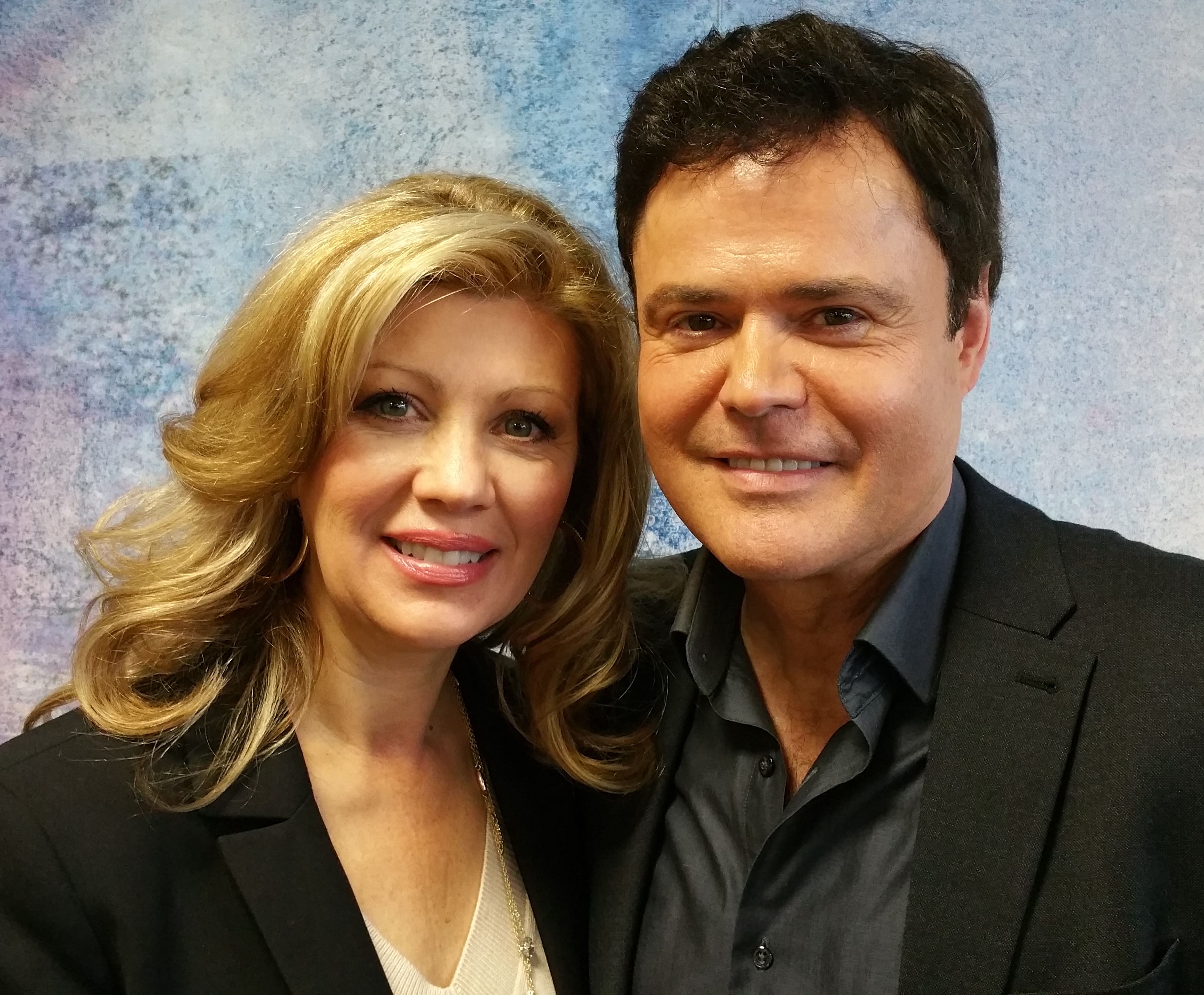 Donny Osmond and Debbie Osmond in black formal attires.